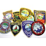 A collection of mostly American Police Department sleeve patches, including Orlando, Sarasota and