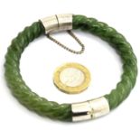 Jade Oriental bangle, with safety chain. D: 8 cm, 45g. P&P Group 1 (£14+VAT for the first lot and £