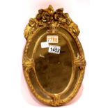 An oval gesso gilt framed wall mirror, overall 34 x 22 cm. Condition report: Gilt loss of around