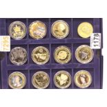 Twelve mixed Queen Elizabeth coins in a collectors box including enamelled examples. P&P Group 2 (£