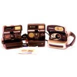 Three Polaroid cameras, black Polaroid 660, silver Polaroid 600 and black Polaroid 600, all have