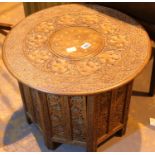 Circular Indian carved campaign table, D: 60 cm. Not available for in-house P&P, contact Paul O'
