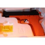 Airsoft 6mm BB gun in orange wrapping. P&P Group 2 (£18+VAT for the first lot and £3+VAT for