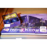 Pair of oriental iron directional balls and a photographic panoramic view of Hong Kong hardback book