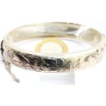 Hallmarked silver engraved bangle with safety chain, 26g. P&P Group 1 (£14+VAT for the first lot and