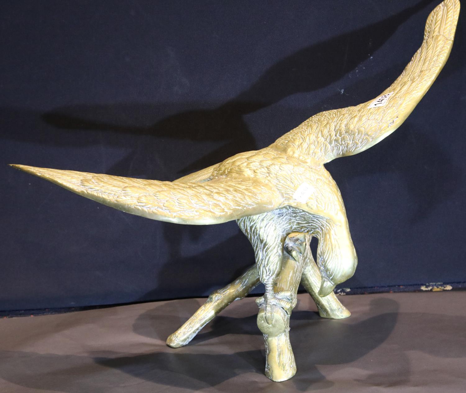 Large brass eagle perched on a rock, wingspan: 65 cm. P&P Group 3 (£25+VAT for the first lot and £