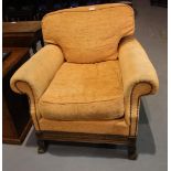 Upholstered Victorian armchair with scroll arms and carved frame, on paw supports. Not available for