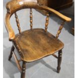 Victorian elm framed and seated Captains chair with stretcher. Not available for in-house P&P,