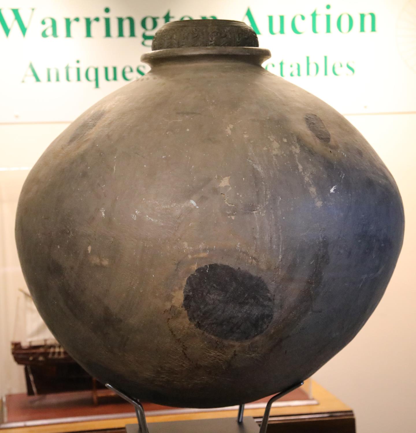 A large 18th century Chinese stoneware egg fermenting chamber, raised on museum plinth with later