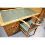 Oak twin pedestal desk having two drawers and tambour front enclosing shelves with matching chair,