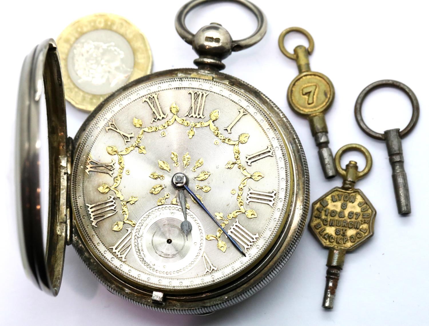 Hallmarked silver pocket watch, London assay with ornate silver dial and vintage watch keys, not