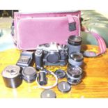 Olympus OM10 SLR camera body and a selection of lenses. P&P Group 3 (£25+VAT for the first lot