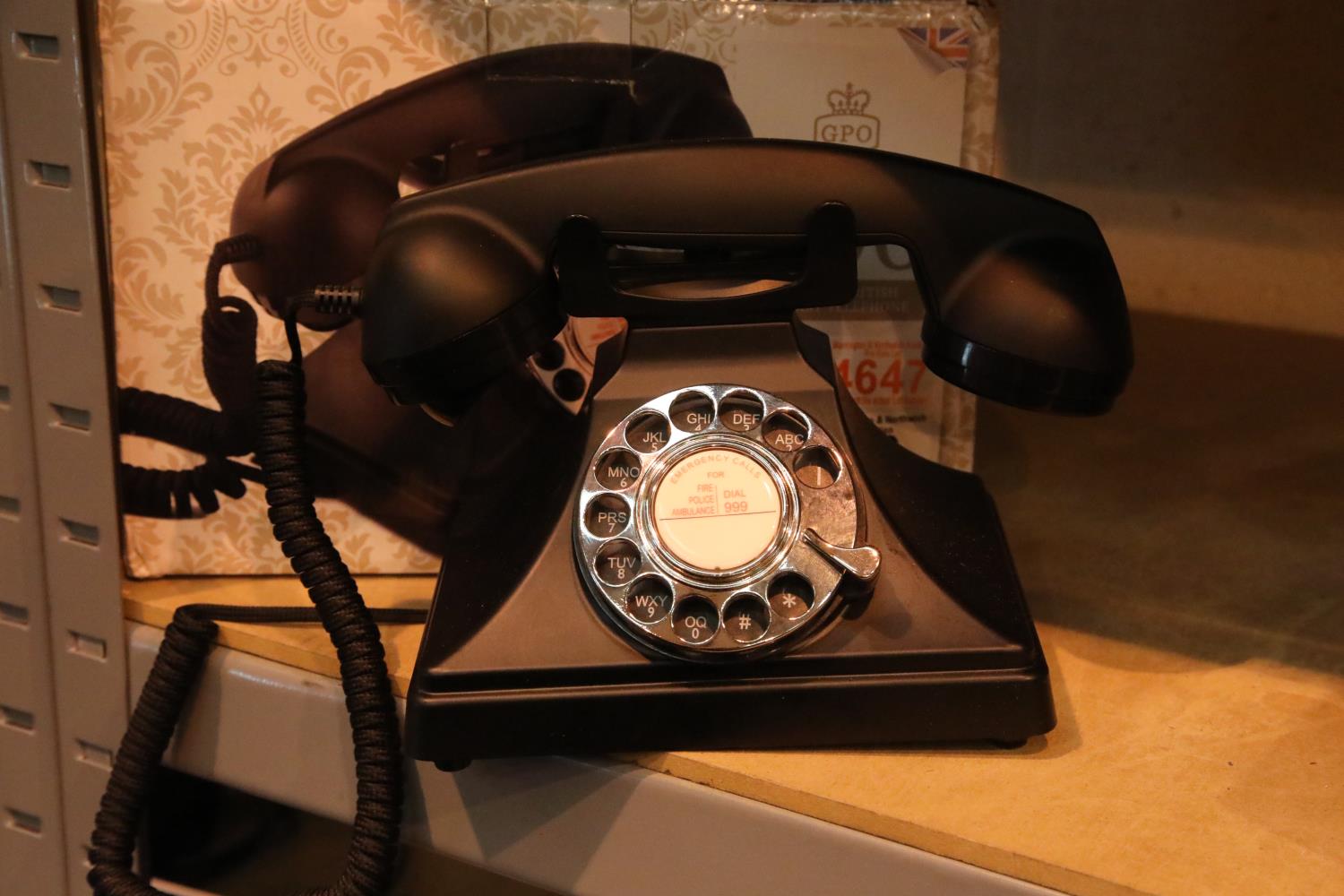 The GPO 200 rotary telephone has a metal base and handset; traditional cloth curly cord; is