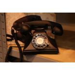 The GPO 200 rotary telephone has a metal base and handset; traditional cloth curly cord; is