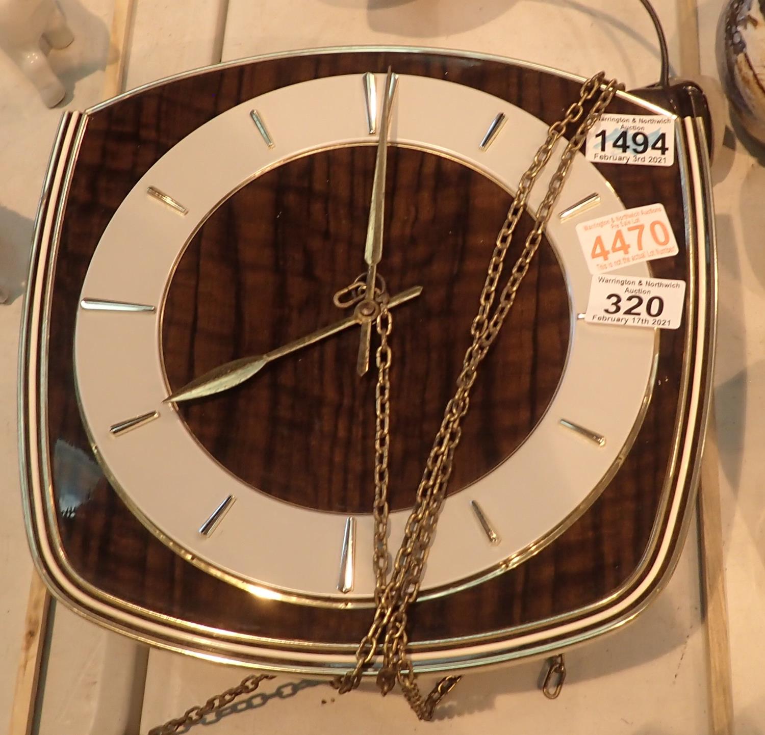 1970's chain driven wall clock, lacking weights and pendulum, not working at time of lotting, dial