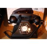 The GPO 200 rotary telephone has a metal base and handset; traditional cloth handset curly cord & is