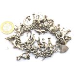 Heavy-gauge 925 Silver charm bracelet with 24 charms, L: 19 cm, 126g. P&P Group 1 (£14+VAT for the