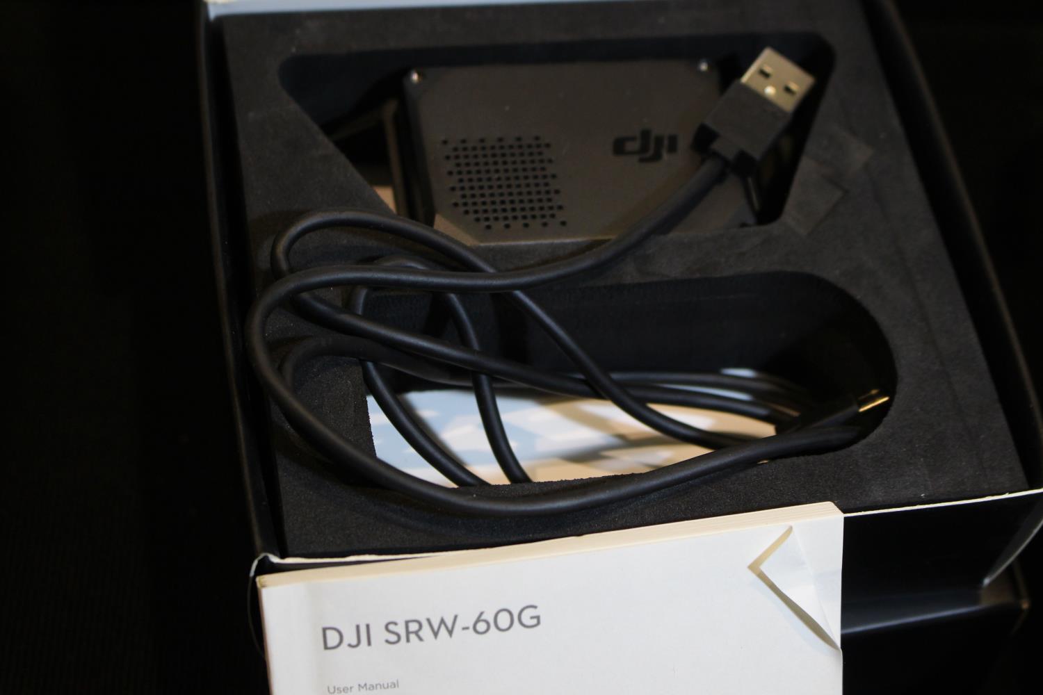 Two dji SRW-60G Short Range Wireless HD video links, one unopened, the second without its mount. P&P