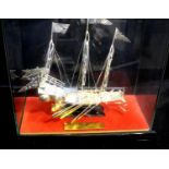 Oriental white metal junk in glass case, possibly silver, case 28 x 26 x 13 cm. Not available for