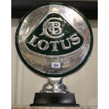 Large chrome Lotus sign on wooden base, L: 38 cm. P&P Group 3 (£25+VAT for the first lot and £5+