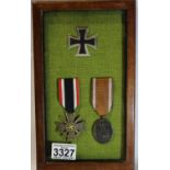 Three German WWII restruck medals comprising Iron Cross, War Merit Cross and West Wall medal,