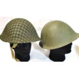 Two European Cold War era helmets, each with liners, one with netting. P&P Group 3 (£25+VAT for