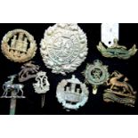 Nine mixed British military cap badges in varying condition. P&P Group 1 (£14+VAT for the first