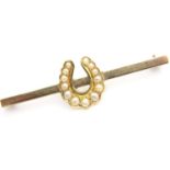 Presumed 9ct gold horseshoe brooch set with seed pearls, 3.4g. P&P Group 1 (£14+VAT for the first