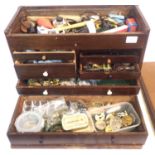 Watch repair cabinet with drop-down front, having tools and parts contents. Not available for in-