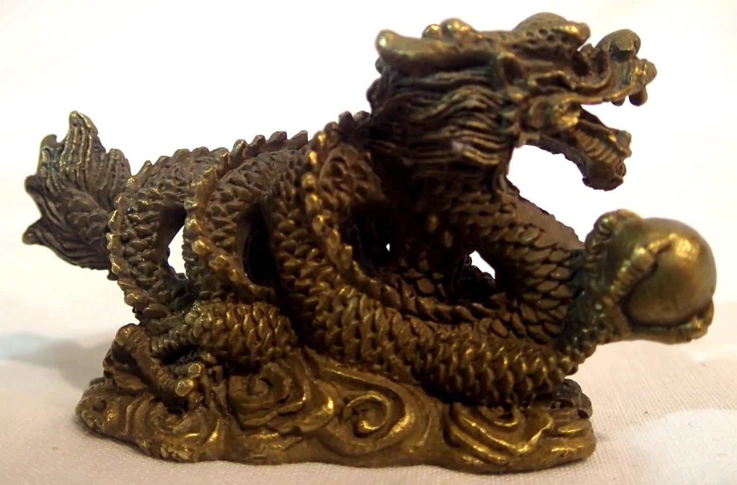 Brass Oriental dragon with ball, L: 65 mm. P&P Group 1 (£14+VAT for the first lot and £1+VAT for