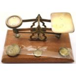 Set of brass postal scales on a wooden mount. P&P Group 2 (£18+VAT for the first lot and £3+VAT