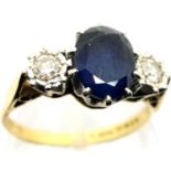 18ct gold sapphire and diamond three stone ring, centre sapphire approximately 1cts, size L/M, 3.7g.