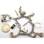 Sterling silver charm bracelet with eleven charms, 43g. P&P Group 1 (£14+VAT for the first lot
