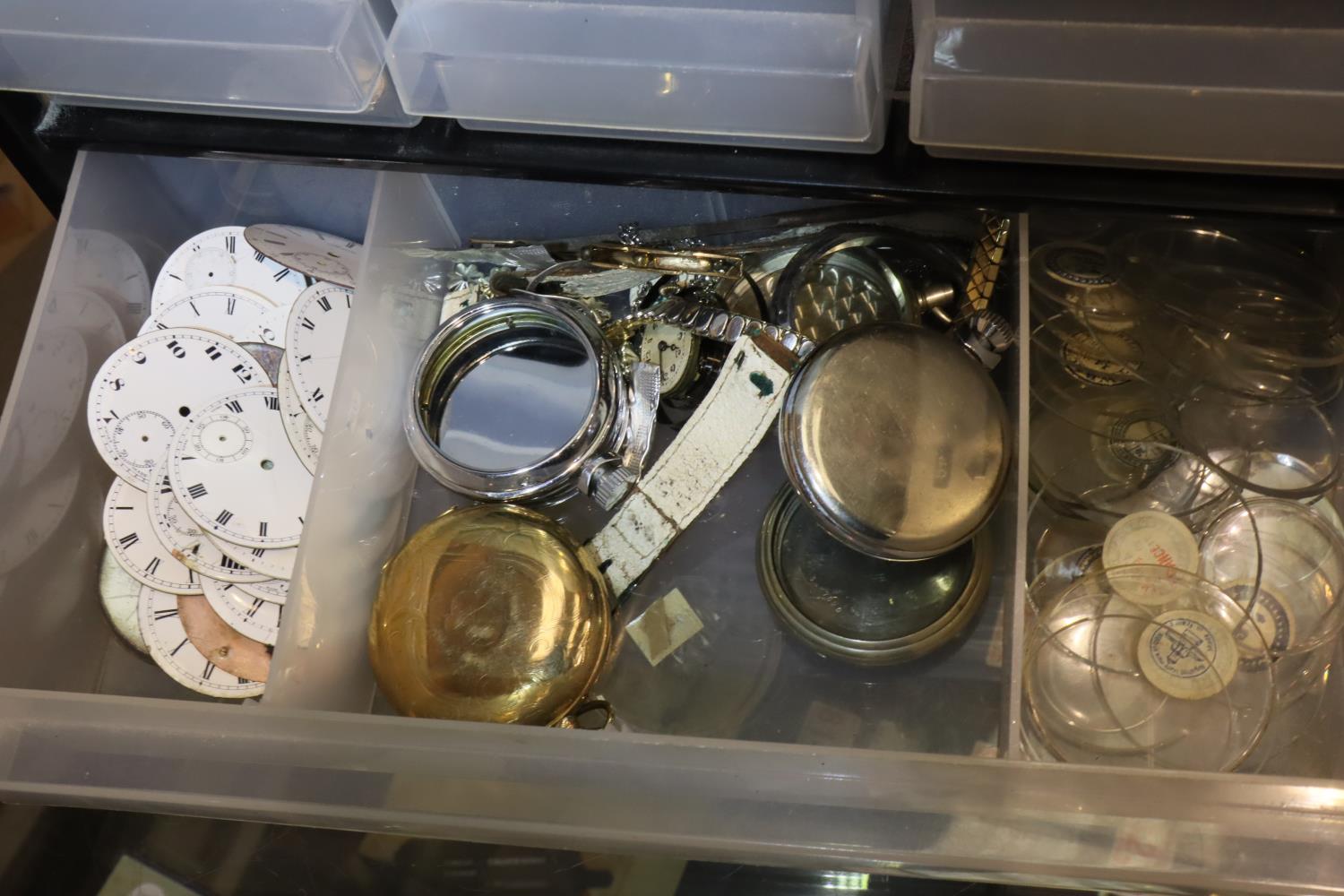 Cabinet containing a quantity of pocket watch parts. P&P Group 1 (£14+VAT for the first lot and £1+