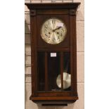 Early 20thC oak case wall clock with glazed pendulum display door. Not available for in-house P&P,