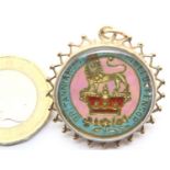 9ct gold bound pendant with enamel and gilt shilling. P&P Group 1 (£14+VAT for the first lot and £
