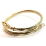 A yellow metal sprung articulated snake form bangle, marked Germany, 15g. P&P Group 1 (£14+VAT for