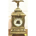 J Martin, a French lacquered brass table clock with enamelled chapter ring chiming on a gong and