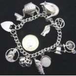 Silver charm bracelet with eleven charms, 43g. P&P Group 1 (£14+VAT for the first lot and £1+VAT for