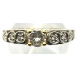 A modern 18ct white and yellow gold solitaire diamond dress ring, the central stone of approximately