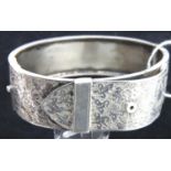 A presumed silver buckle snap bangle, unmarked, 24g. P&P Group 1 (£14+VAT for the first lot and £1+