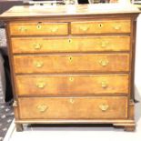 A George III oak and mahogany cross banded chest comprising two short above four long graduated