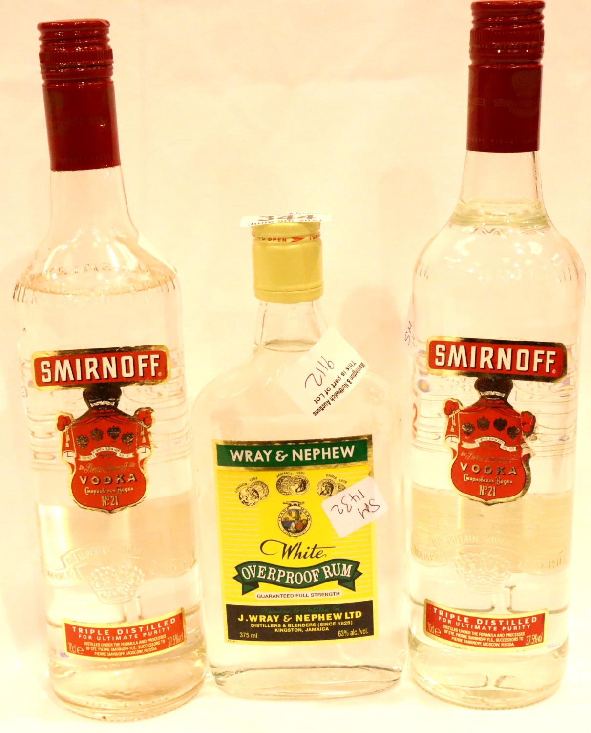 Two bottles of Smirnoff Vodka and a half bottle of Wray and Nephew white rum. P&P Group 3 (£25+VAT