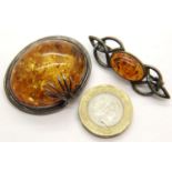 Two vintage silver bound Baltic amber brooches, largest L: 40 mm. P&P Group 1 (£14+VAT for the first
