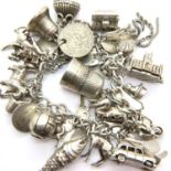 Silver charm bracelet with 31 charms, 126g. P&P Group 1 (£14+VAT for the first lot and £1+VAT for