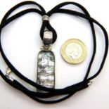 Silver pendant on a fabric chain, 27g. P&P Group 1 (£14+VAT for the first lot and £1+VAT for