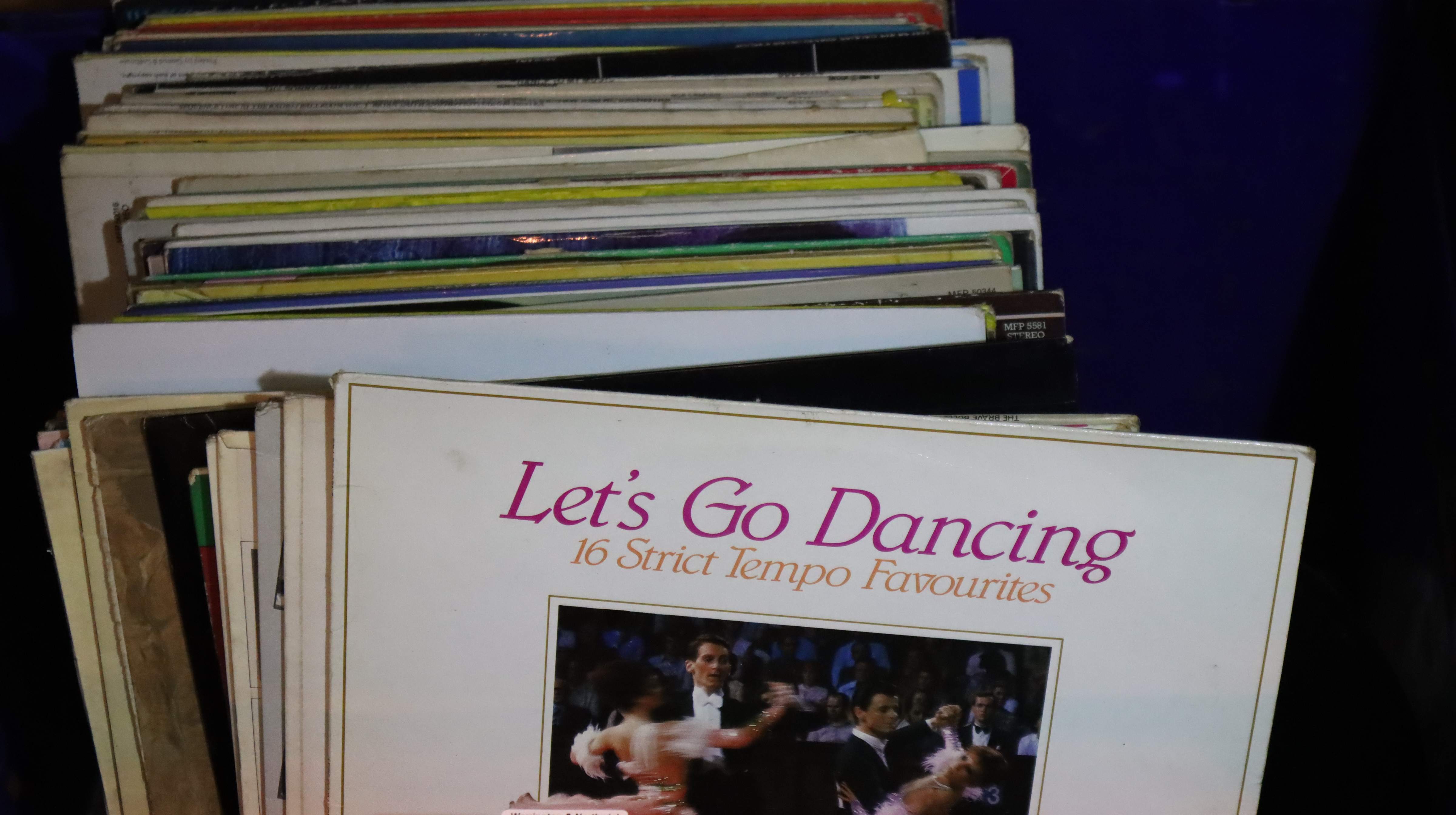 A box of mixed vinyl records to include Lets Go Dancing and Tickled Pink. Not available for in-house