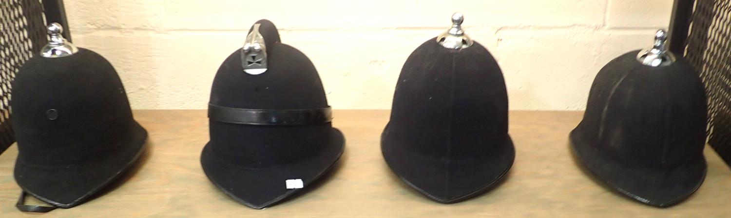 Four vintage British Police helmets lacking badges. Not available for in-house P&P, contact Paul O'