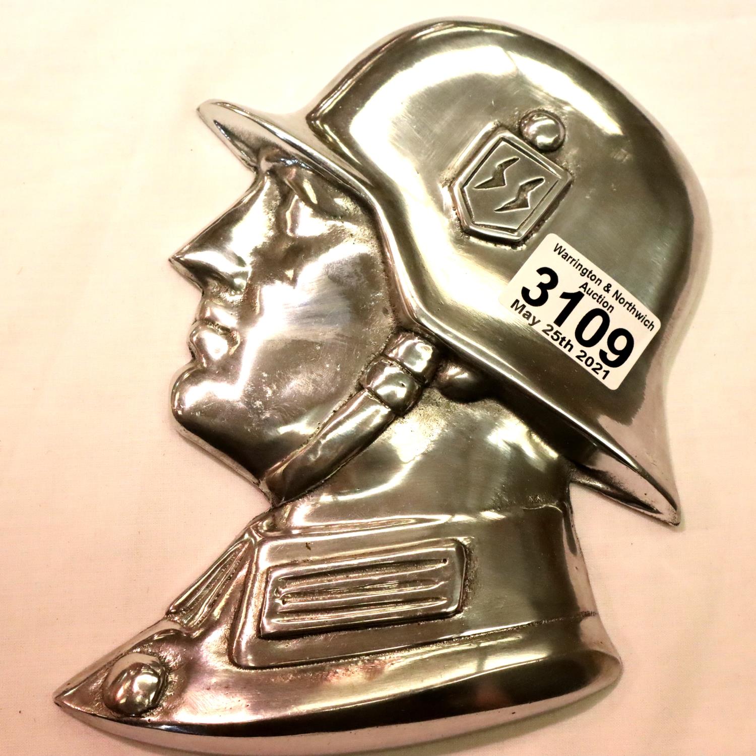 A polished metal SS soldiers side profile, wall or door mounting with threaded holes verso, H: 21