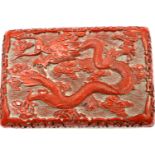 Rectangular cinnabar box with enamel interior and dragon decoration to hinged lid, 16 x 10 x 6 cm H.